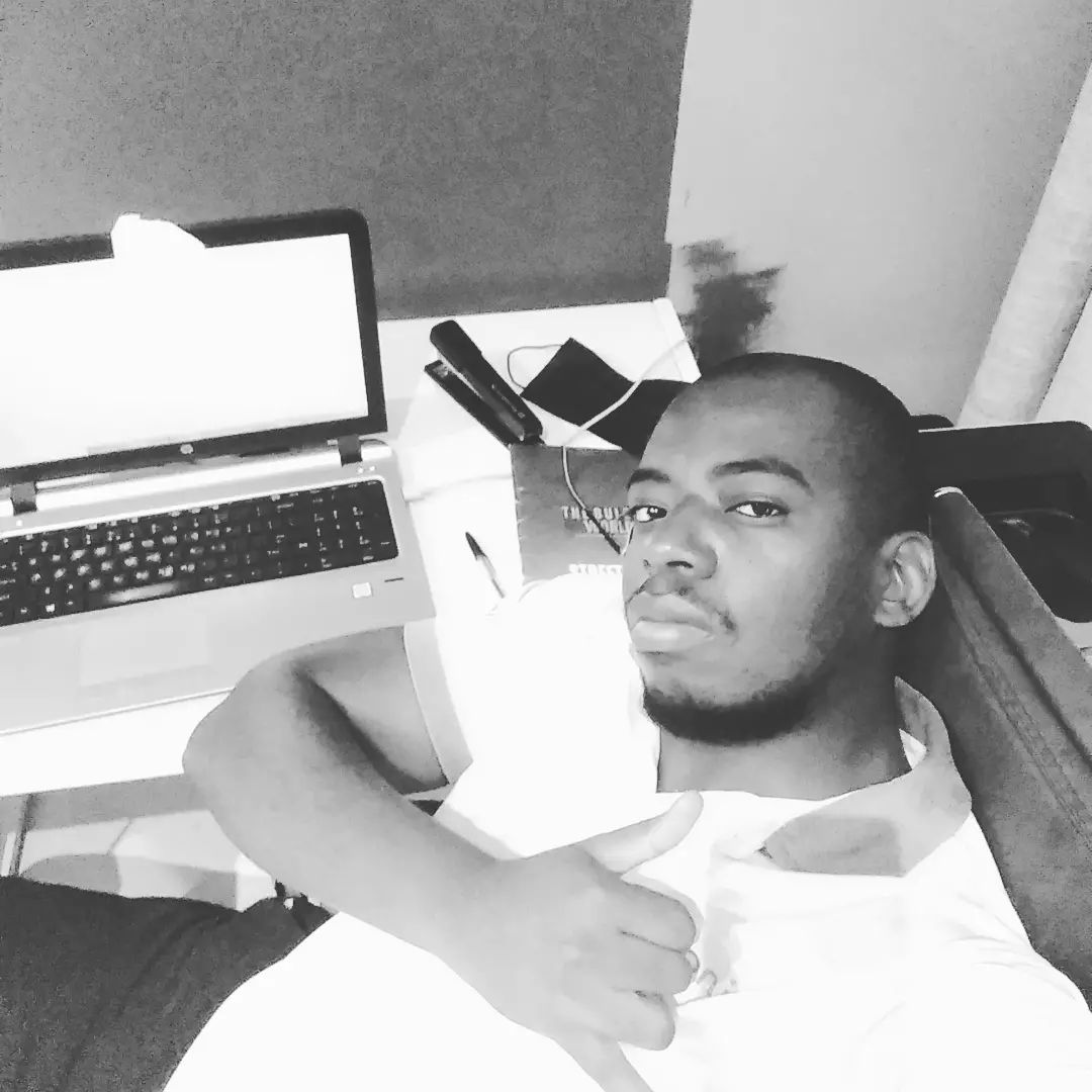 Valentine Kabo Butale working at his desk