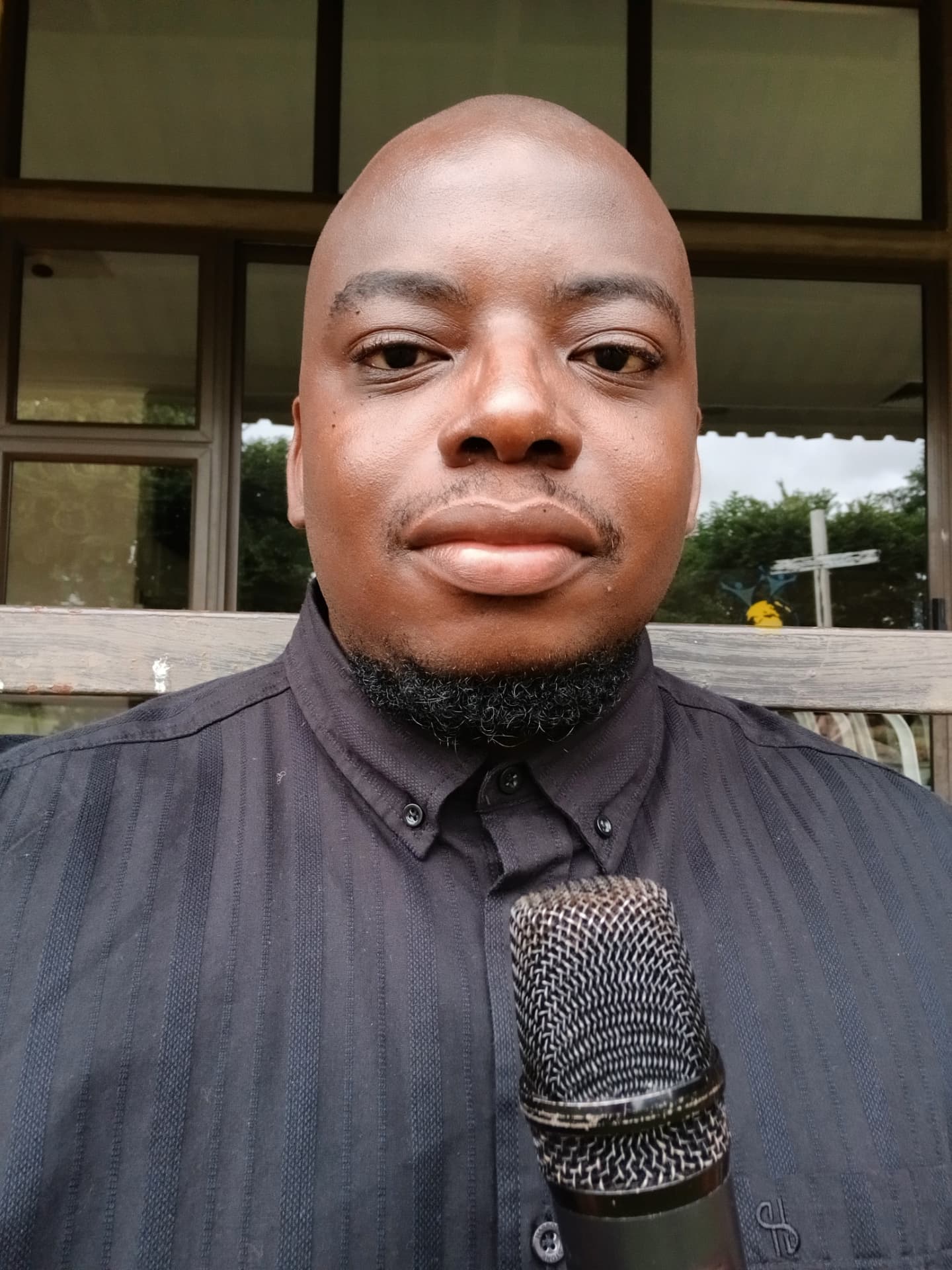 Valentine Kabo Butale holding a microphone